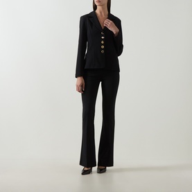 Model wearing Joseph Ribkoff Statement Button Blazer in black with gold statement buttons, styled with matching black flared trousers and heels.