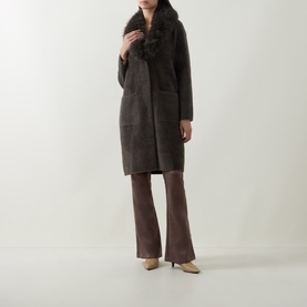 Model wearing Joseph Ribkoff Faux Fur Trim Knitted Cardigan in Avocado with faux fur shawl collar, styled with flared trousers