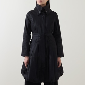 Model wearing Joseph Ribkoff black belted coat with spread collar, balloon hem, and long sleeves in polyester-nylon blend