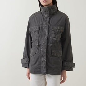 Model wearing Joseph Ribkoff Avocado nylon coat with high collar, four patch pockets and subtle textured pattern, styled with white trousers