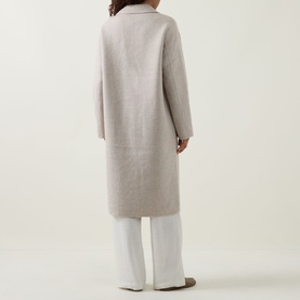 Model wearing Joseph Ribkoff oatmeal wool-blend longline coat, back view, styled with white wide-leg trousers