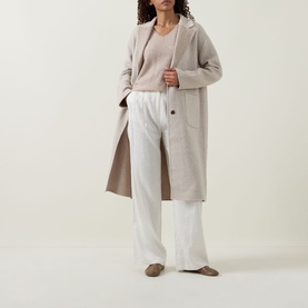 Model wearing Joseph Ribkoff Oatmeal longline wool-blend coat, styled with matching knit top and wide-leg white trousers.