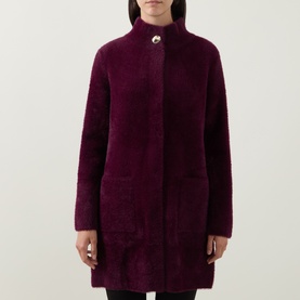 Model wearing Joseph Ribkoff Statement Button Knitted Coat in elderberry, featuring mock neck, single statement button, and patch pockets