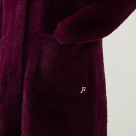 Joseph Ribkoff Statement Button Knitted Coat in Elderberry, close-up of patch pocket and logo badge on textured soft-finish fabric.