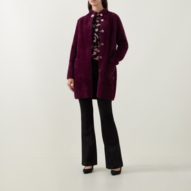 Model wearing Joseph Ribkoff Statement Button Knitted Coat in Elderberry, styled with floral top and black flared trousers.