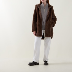 Model wearing Joseph Ribkoff Dark Mink faux shearling coat, styled with grey half-zip top and white wide-leg trousers, black loafers.