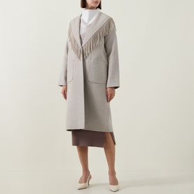 Model wearing Joseph Ribkoff oatmeal coat with fringe trim detail, styled with white top, mauve skirt and cream heels.