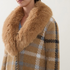 Model wearing Joseph Ribkoff Patch Pocket Faux Fur Knitted Coat in camel/multi check with oversized faux fur collar detail