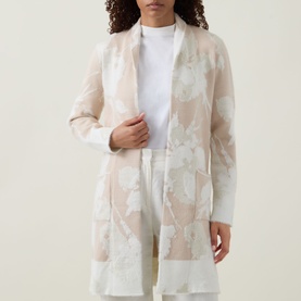 Model wearing Joseph Ribkoff Oatmeal and Winter White floral jacquard longline cover-up, styled with white top and trousers.