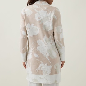 Model wearing Joseph Ribkoff Cover Up in oatmeal and winter white floral jacquard knit, back view showing longline silhouette.