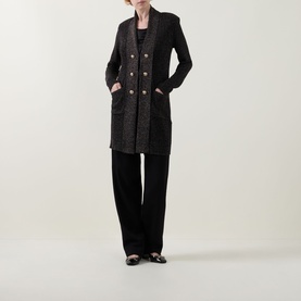 Model wearing Joseph Ribkoff Black/Gold Cover Up, double-breasted with patch pockets, styled with black wide-leg trousers and black flats.