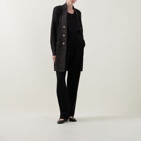 Model wearing Joseph Ribkoff Black/Gold Cover Up with gold buttons, styled with black wide-leg trousers and black vest top.