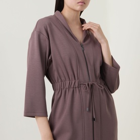 Model wearing a mauve zip-front robe with drawstring waist and three-quarter length sleeves, close-up detail view.