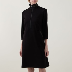 Model wearing Joseph Ribkoff black dress with high zip neck, three-quarter sleeves and A-line skirt in stretch fabric.