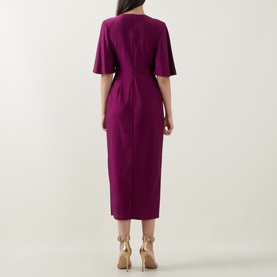 Model wearing Joseph Ribkoff Gathered Hardware-Detail Wrap Dress in Berry Burst, midi length, short flutter sleeves, back view, styled with gold