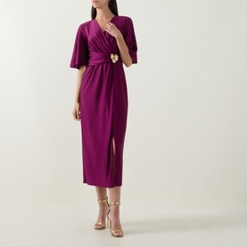 Model wearing Joseph Ribkoff Gathered Hardware-Detail Wrap Dress in Berry Burst, midi length with flutter sleeves, gold hardware waist detail and
