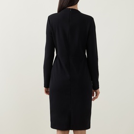 Model wearing Joseph Ribkoff Statement Button Pencil Dress in black, rear view showing structured shoulders, long sleeves and fitted midi silhouette.