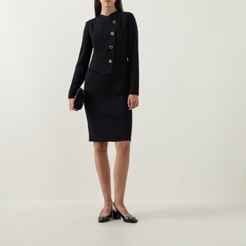 Model wearing Joseph Ribkoff Statement Button Pencil Dress in black with high neck, long sleeves and gold statement buttons, styled with black ballet