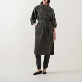 Model wearing Joseph Ribkoff Dress in Avocado, belted midi length with funnel neck and 3/4 sleeves, styled with black trousers and flat shoes
