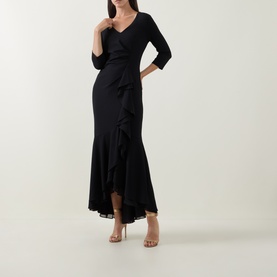 Model wearing Joseph Ribkoff Frill-Detail Layered Ruffle Dress in black with V-neckline, three-quarter sleeves and high-low hem, styled with nude