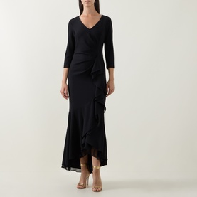 Model wearing Joseph Ribkoff Frill-Detail Layered Ruffle Dress in black, V-neckline, three-quarter sleeves, high-low hem, styled with nude heeled