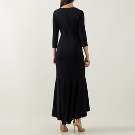 Model wearing Joseph Ribkoff Frill-Detail Layered Ruffle Dress in black, rear view showing zip, three-quarter sleeves and high-low ruffle hem.