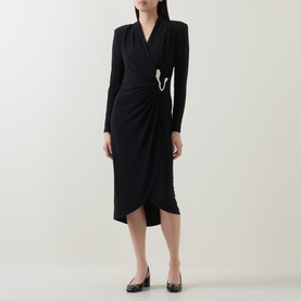 Model wearing Joseph Ribkoff black wrap midi dress with ruched detail, crystal brooch pin, long sleeves and V-neckline.
