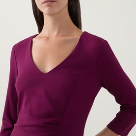 Model wearing Joseph Ribkoff Dress in Berry Burst, featuring a V-neckline and three-quarter length sleeves in a fitted silhouette.