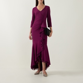 Model wearing Joseph Ribkoff Berry Burst maxi dress with V-neck, three-quarter sleeves, ruched waist and asymmetric ruffle skirt, styled with grey