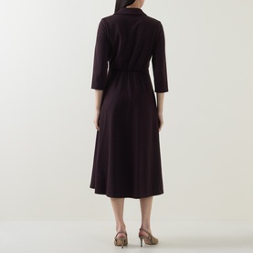 Model wearing dark burgundy midi shirt dress with three-quarter sleeves, belted waist, and flared skirt, styled with nude heels