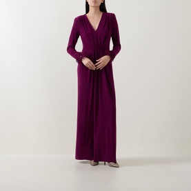 Model wearing purple long-sleeve V-neck maxi dress with gathered waist detail, styled with pointed-toe heels