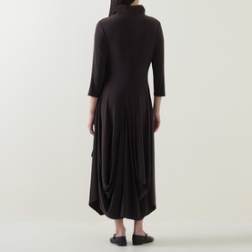 Model wearing Joseph Ribkoff Dress in Mocha, back view, turtleneck, three-quarter sleeves, draped midi skirt with asymmetric hem