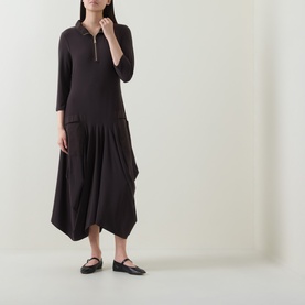 Model wearing Joseph Ribkoff mocha dress with zip collar, three-quarter sleeves and draped asymmetric hem, styled with black flat shoes