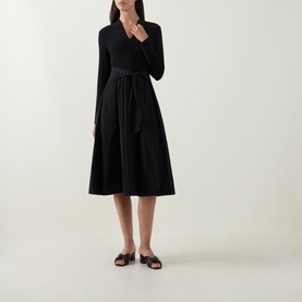 Model wearing Joseph Ribkoff Contrast Self-Tie Flared Dress in black, V-neck, long sleeves, self-tie belt, midi flared skirt, styled with black flat