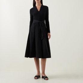Model wearing Joseph Ribkoff Contrast Self-Tie Flared Dress in black, V-neck, long sleeves, self-tie belt, midi flared skirt, styled with black slide