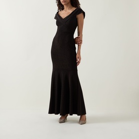 Model wearing Joseph Ribkoff bronze maxi dress with V-neckline, cap sleeves, and fishtail hem, styled with nude heels