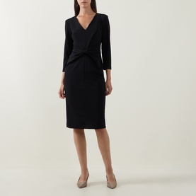 Model wearing Joseph Ribkoff Gathered Bow Pencil Dress in black, V-neckline, three-quarter sleeves, styled with nude heels