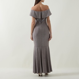 Model wearing Joseph Ribkoff Off-The-Shoulder Mermaid Dress in taupe, showing rear view with fitted silhouette and mermaid-flare skirt