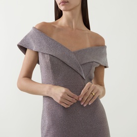 Model wearing Joseph Ribkoff Off-The-Shoulder Mermaid Dress in taupe lurex, off-shoulder folded neckline, fitted silhouette, styled with a gold ring