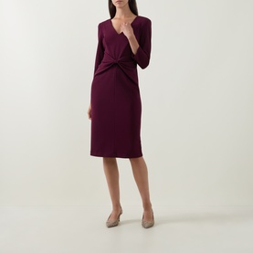 Model wearing Joseph Ribkoff Gathered Bow Pencil Dress in Elderberry, V-neckline, three-quarter sleeves, midi length, styled with nude heels.