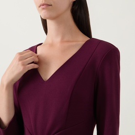 Model wearing Joseph Ribkoff Gathered Bow Pencil Dress in Elderberry, featuring a V-neckline and three-quarter length sleeves.
