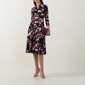 Model wearing Joseph Ribkoff Printed Wrap Dress in black/multi floral print, midi length with flared skirt and three-quarter sleeves, styled with