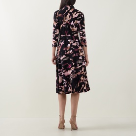 Model wearing Joseph Ribkoff Printed Wrap Dress in black/multi floral print, three-quarter sleeves, flared midi skirt, back view, styled with nude