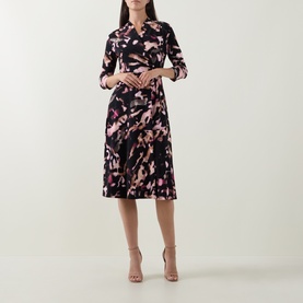 Model wearing Joseph Ribkoff Printed Wrap Dress in black/multi floral print, midi length, three-quarter sleeves, flared skirt, styled with nude