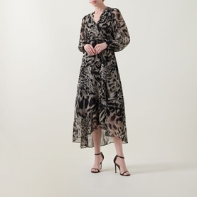Model wearing Joseph Ribkoff grey multi animal print midi dress with long sleeves and asymmetric hem, styled with black strappy heels
