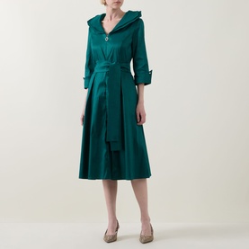 Model wearing Joseph Ribkoff Dress in Opulent Green, featuring a wide collar, three-quarter sleeves, belted waist and full midi skirt.