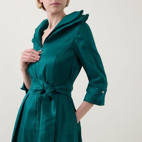 Model wearing Joseph Ribkoff Dress in Opulent Green with ruffle collar, three-quarter sleeves, and self-tie waist belt, close-up detail view.