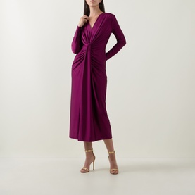 Model wearing Joseph Ribkoff Draped Cinched Dress in Berry Burst, featuring V-neckline, twisted front detail and long sleeves, styled with nude heels