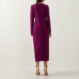 Model wearing Joseph Ribkoff Draped Cinched Dress in Berry Burst, midi-length with long sleeves and cinched waist, back view, styled with gold heeled