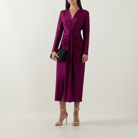 Model wearing Joseph Ribkoff Draped Cinched Dress in Berry Burst, V-neck, gathered twist front, long sleeves, midi length, styled with black clutch